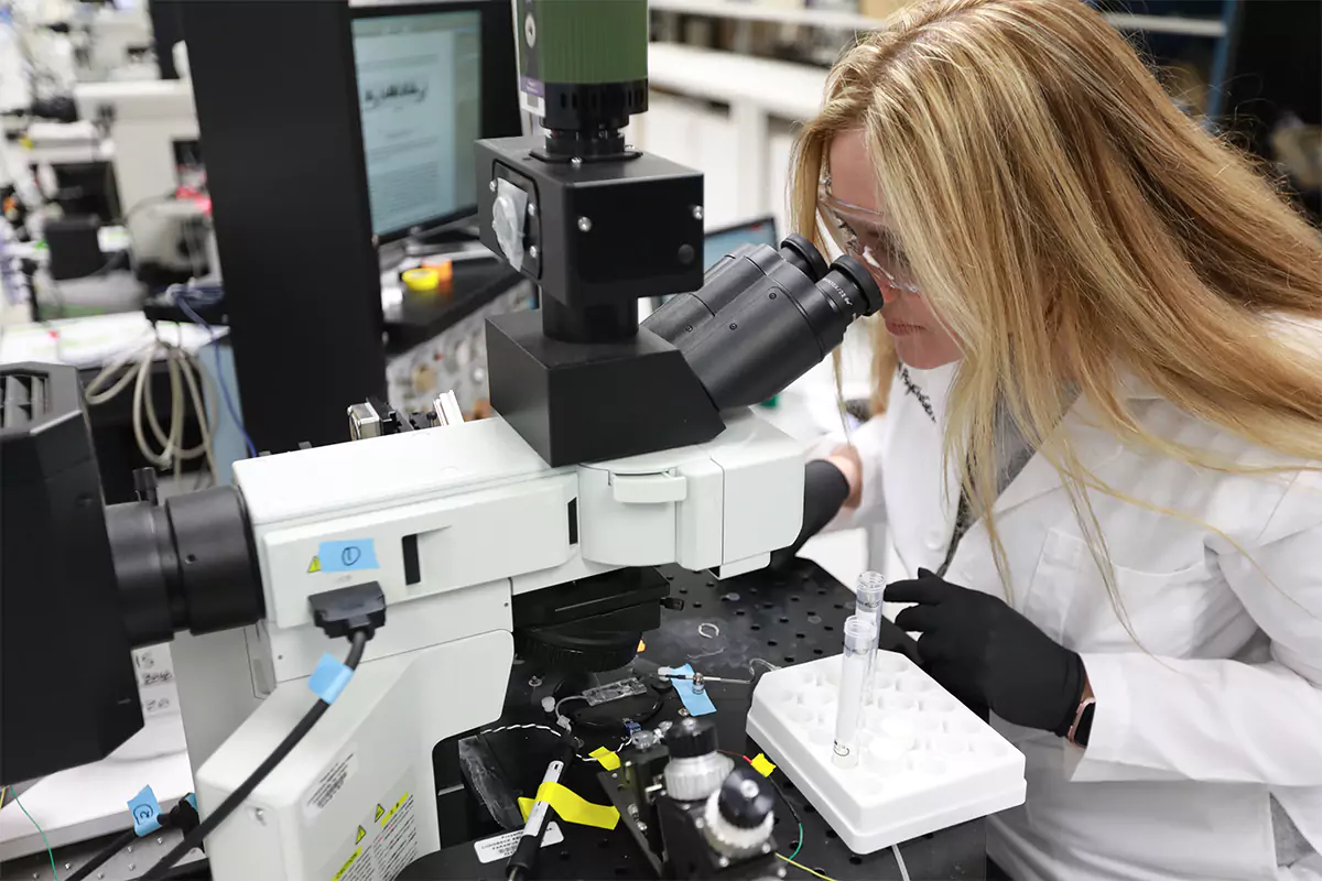 scientist woman using a microscope